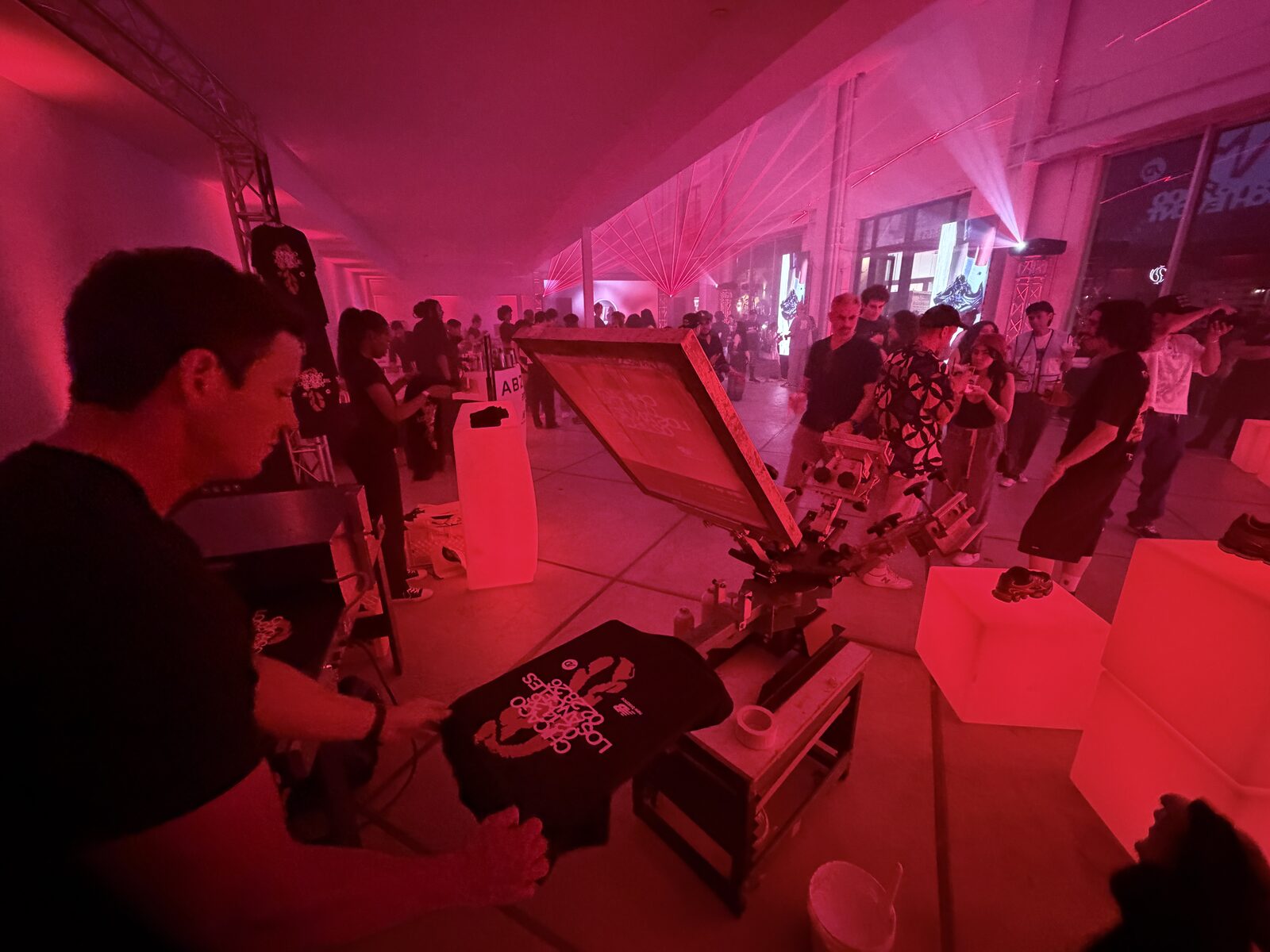 Guest holding a freshly printed shirt from the shirt bar