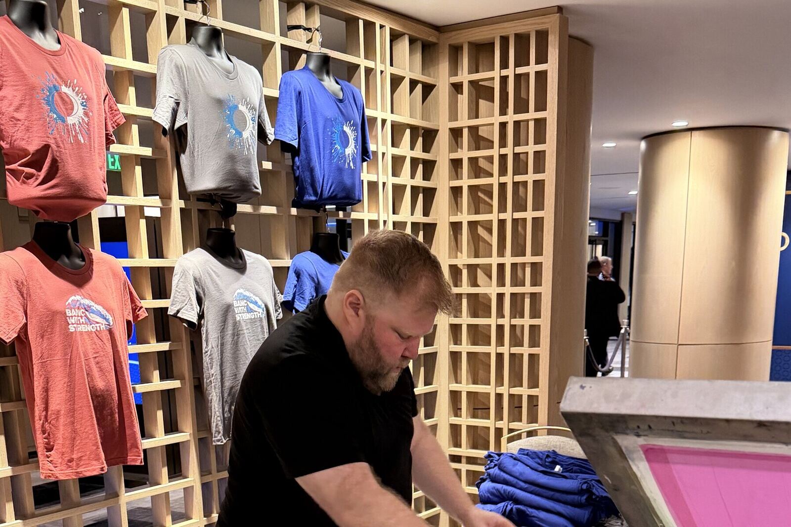 Rack of finished custom shirts at the shirt bar
